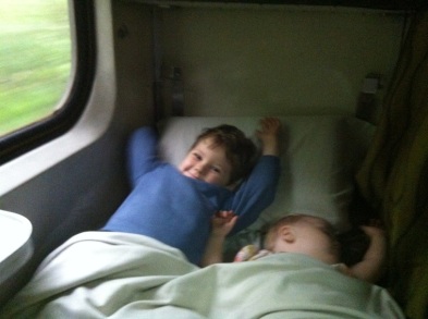 Sleeping on a train, despite her brother.